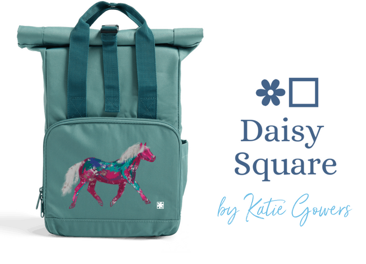 A photograph of a turquoise bag with a drawing of a pony printed on it in shades of pink, blue and silver.